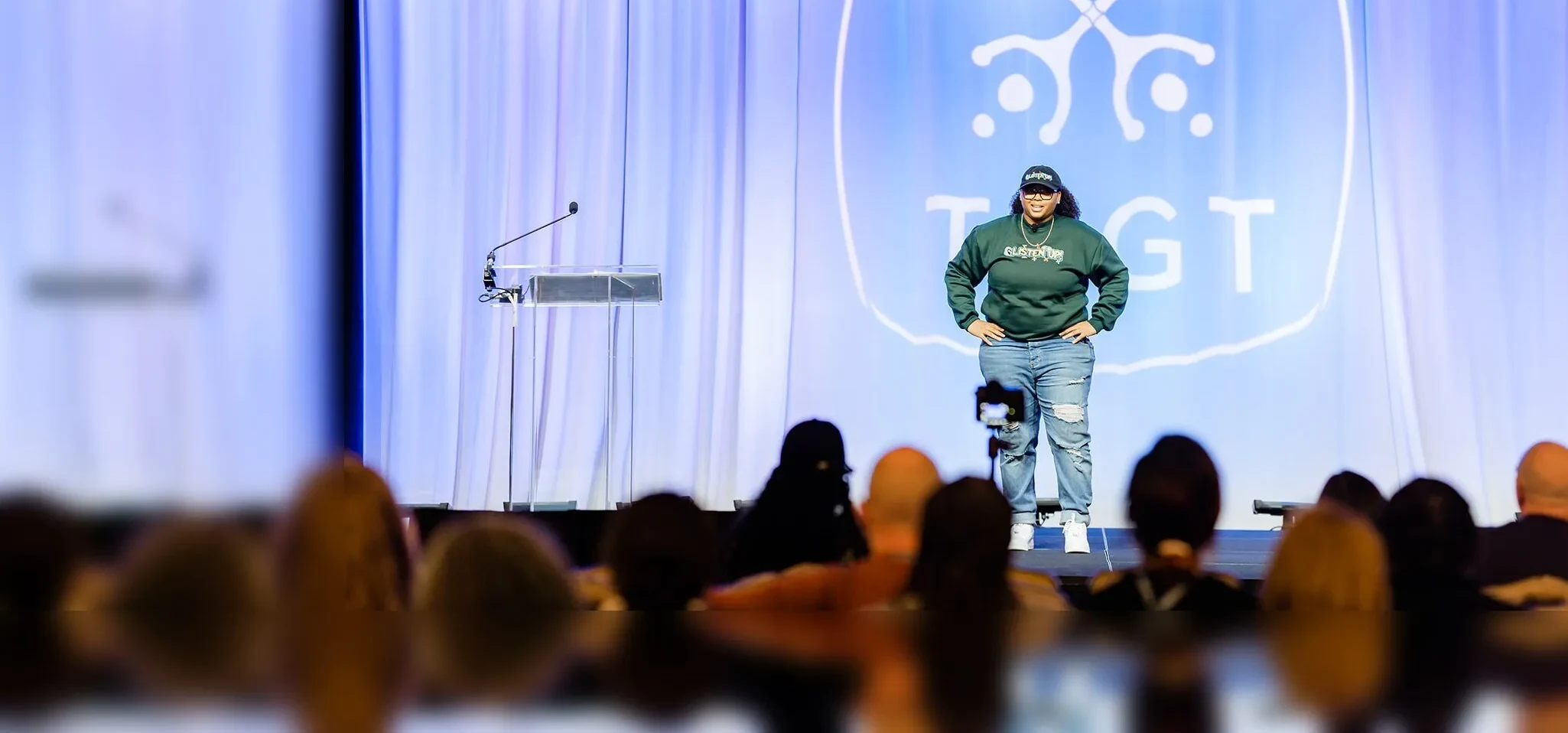 Dajae Williams speaking on stage at a conference