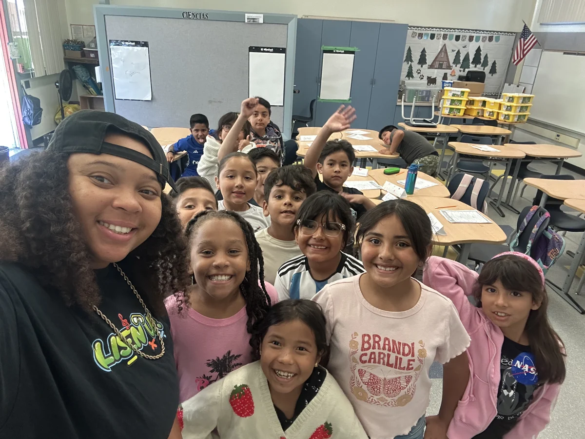 Dajae taking a selfie with a group of smiling students
